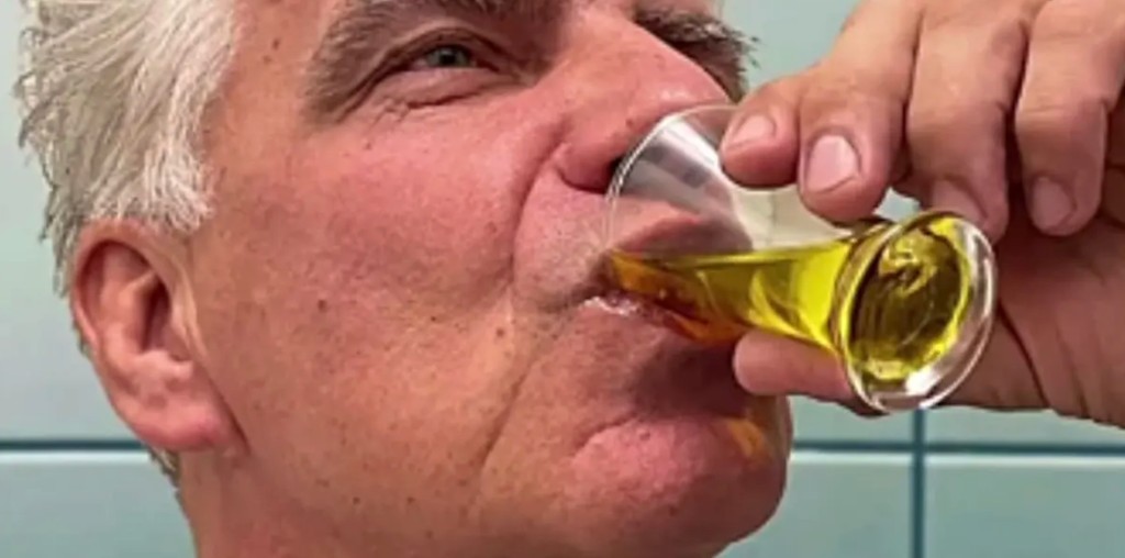 Person taking a daily wellness drop as part of a morning routine
